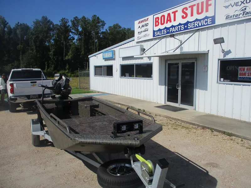 Slide: The Image of 2025 Gator Tail 1750 Savage boat outside Boat Stuf sales and service shop. - 2