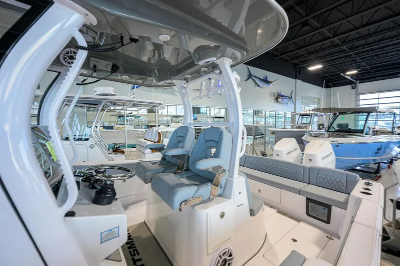 Slide: The Image of 2026 Sportsman Heritage 321 Center Console boat interior in showroom setting. - 15