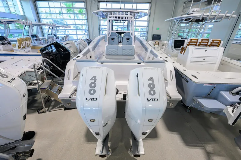 Slide: The Image of 2026 Sportsman Heritage 321 Center Console with twin Mercury 400 V10 engines in showroom. - 2