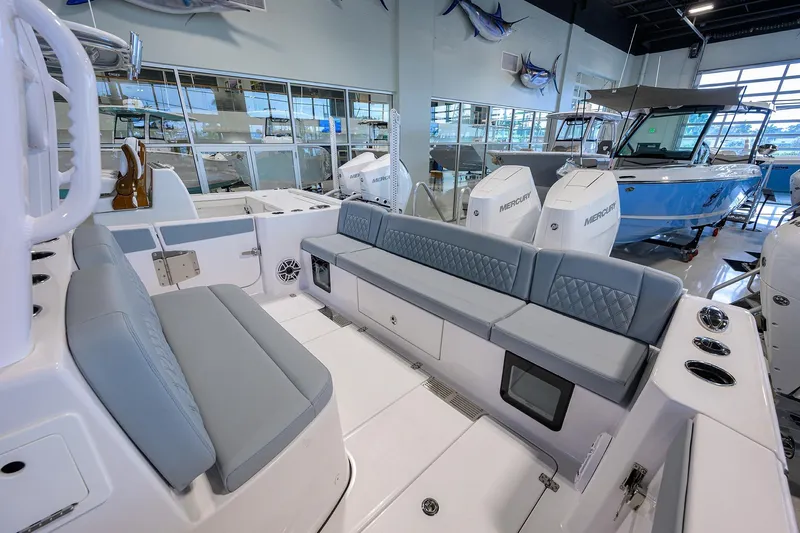 Slide: The Image of 2026 Sportsman Heritage 321 Center Console boat interior with seating and Mercury engines. - 30