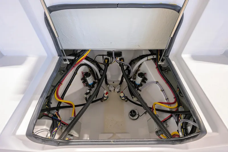 Slide: The Image of 2026 Sportsman Heritage 321 Center Console wiring compartment with organized cables and components. - 32