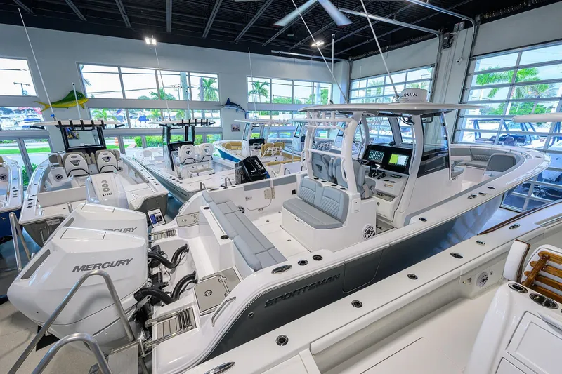 Slide: The Image of 2026 Sportsman Heritage 321 Center Console boat in showroom with Mercury engines. - 40