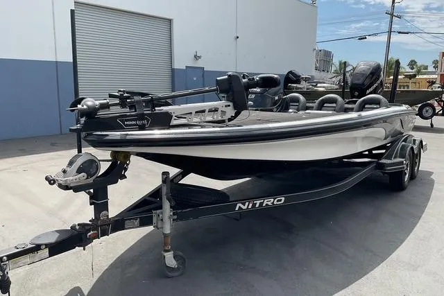 Slide: The Image of 2015 Nitro Z-9 boat on trailer, parked outdoors near industrial building. - 4