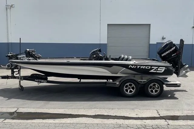 Slide: The Image of 2015 Nitro Z-9 boat with Mercury engine on trailer, parked outside a building. - 5