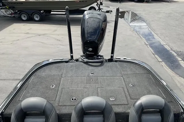 Slide: The Image of 2015 Nitro Z-9 boat with three seats and an outboard motor, parked on a concrete surface. - 8