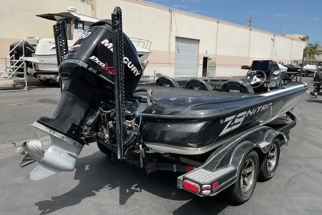 Slide: The Image of 2015 Nitro Z-9 boat with Mercury Pro XS engine in a parking lot. - 9
