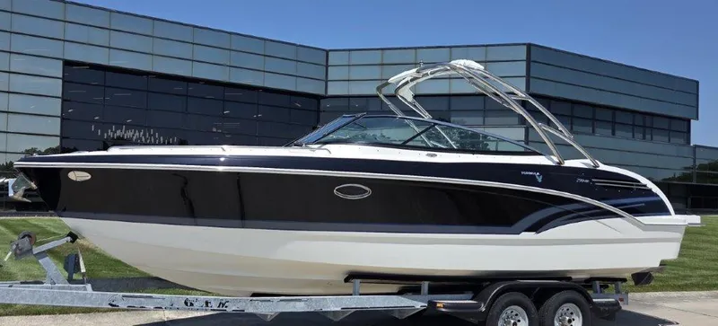 Slide: The Image of 2016 Formula 290 Bowrider boat on trailer, parked outside modern glass building. - 0