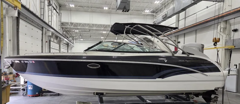Slide: The Image of 2016 Formula 290 Bowrider boat in a spacious indoor facility. - 1