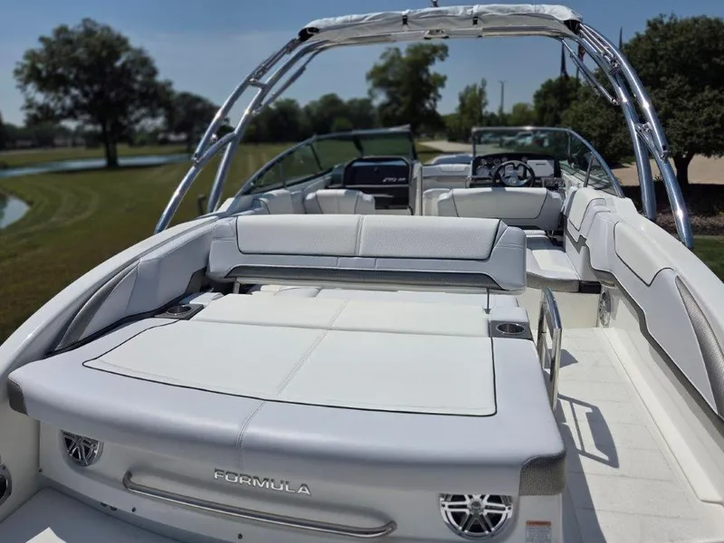 Slide: The Image of 2016 Formula 290 Bowrider boat with spacious seating and sleek design, parked outdoors. - 22