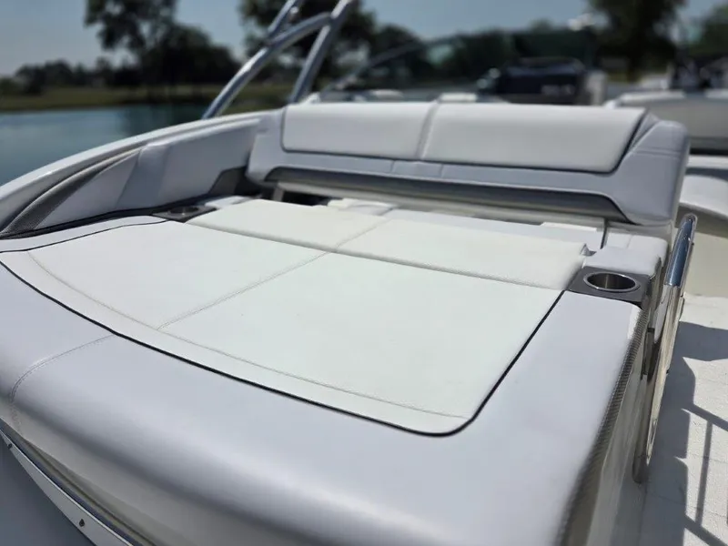 Slide: The Image of 2016 Formula 290 Bowrider boat with spacious sunpad and cup holder, docked by a lake. - 23