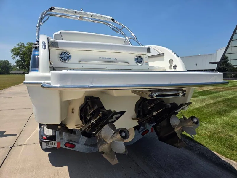 Slide: The Image of 2016 Formula 290 Bowrider boat rear view with dual propellers on a sunny day. - 24