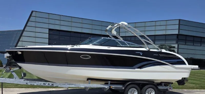 Slide: The Image of 2016 Formula 290 Bowrider boat on trailer, sleek design, parked near modern building. - 29