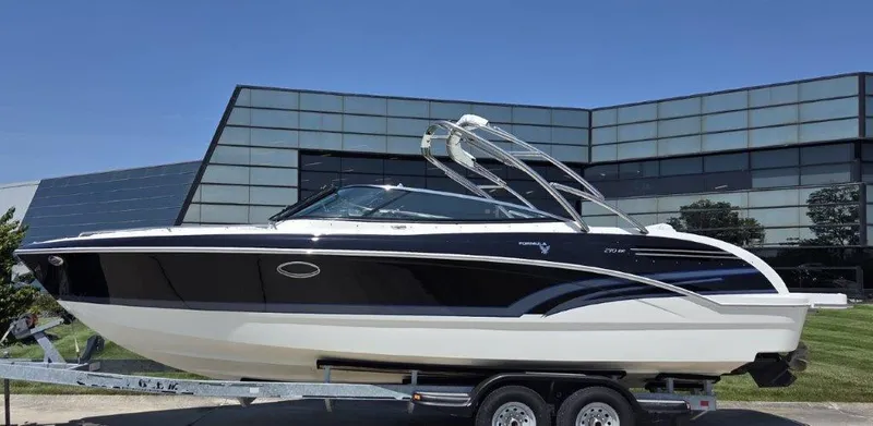 Slide: The Image of 2016 Formula 290 Bowrider boat on trailer, sleek design, parked near modern building. - 30