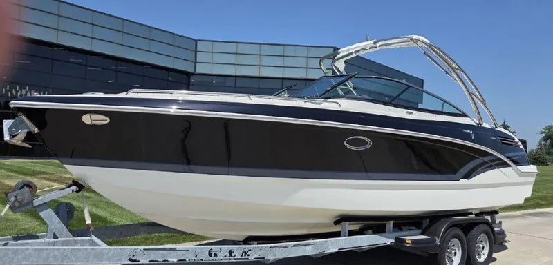 Slide: The Image of 2016 Formula 290 Bowrider boat on trailer, sleek design, parked outdoors. - 31