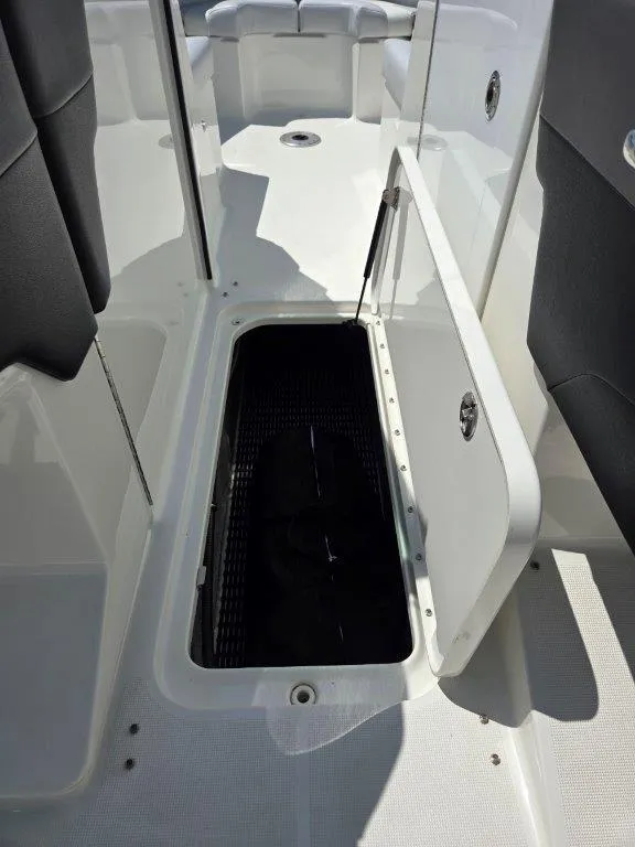 Slide: The Image of 2016 Formula 290 Bowrider storage compartment open, showcasing interior space and design. - 5