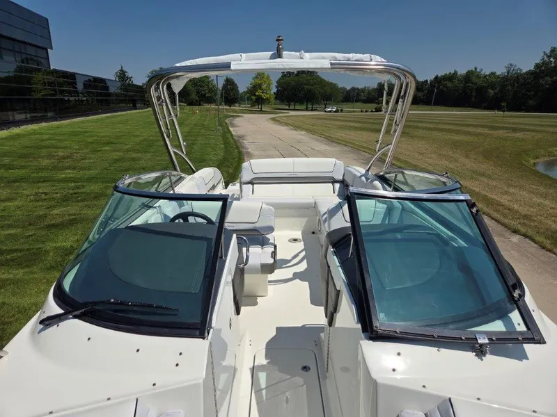 Slide: The Image of 2016 Formula 290 Bowrider boat with open cockpit and windshield, parked on a grassy area. - 9