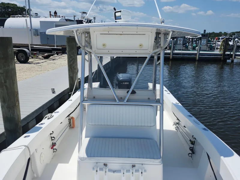 Slide: The Image of 2002 Regulator 23 Classic boat docked at marina, clear sky, calm water. - 12