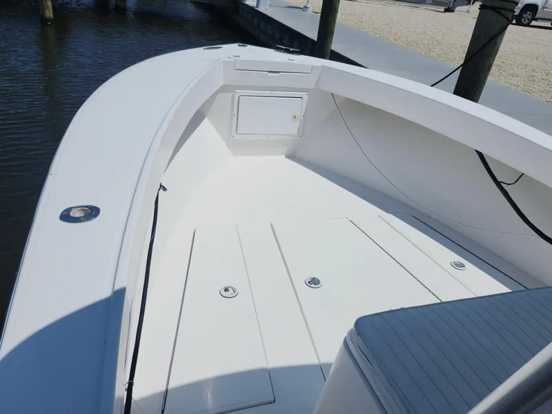 Slide: The Image of 2002 Regulator 23 Classic boat interior with clean white deck and storage compartments. - 16