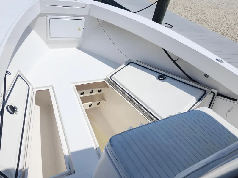 Slide: The Image of 2002 Regulator 23 Classic boat interior with open storage compartments and seating. - 17