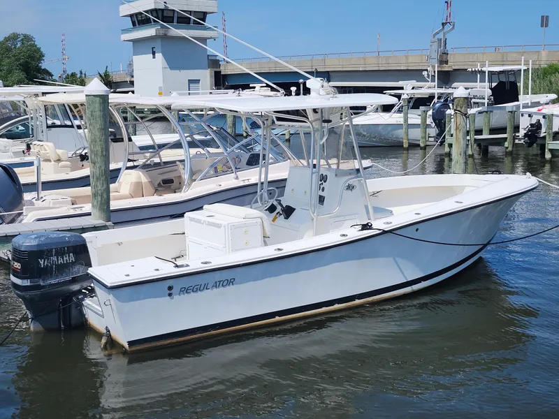 Slide: The Image of 2002 Regulator 23 Classic boat docked at marina with Yamaha outboard motor. - 2