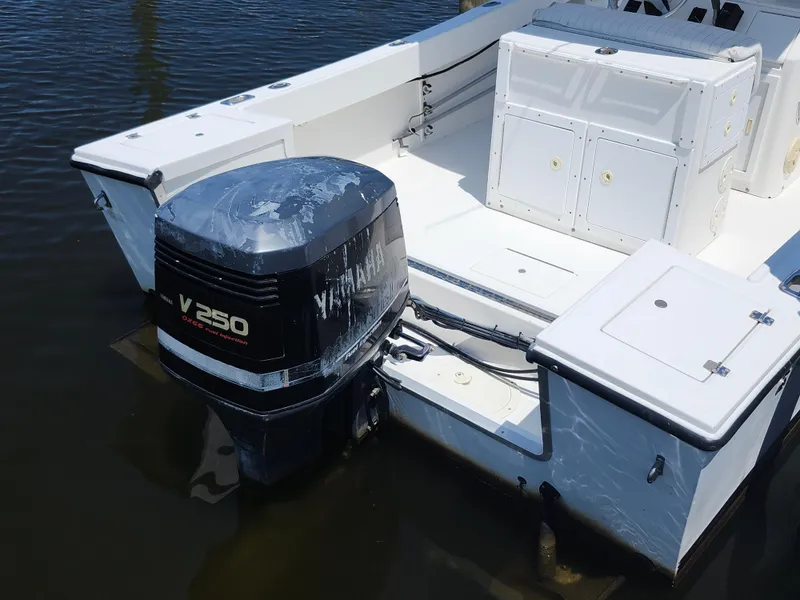 Slide: The Image of 2002 Regulator 23 Classic boat with Yamaha V250 outboard motor on calm water. - 24