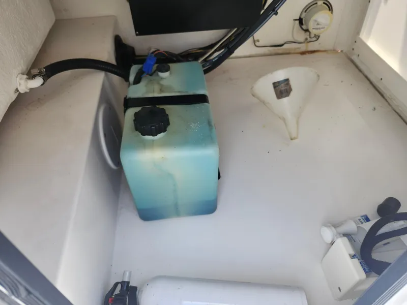 Slide: The Image of 2002 Regulator 23 Classic boat compartment with blue tank and funnel. - 28