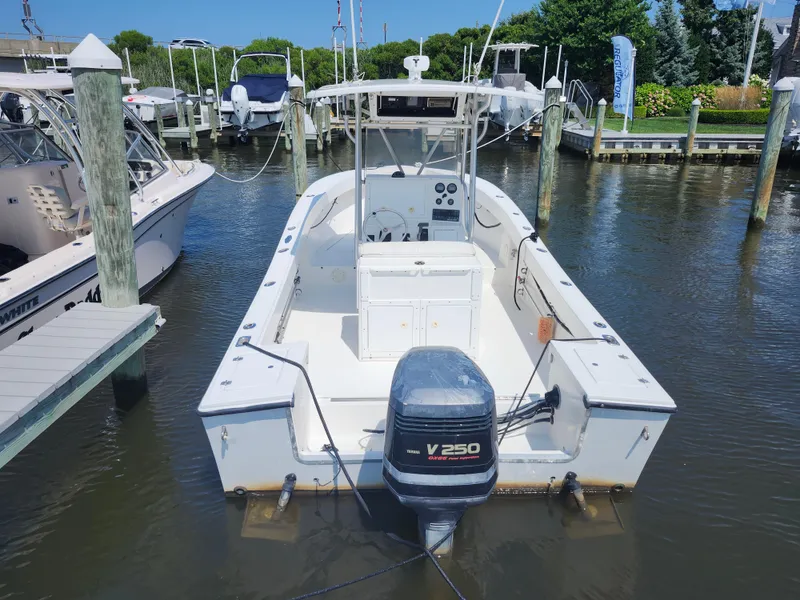 Slide: The Image of 2002 Regulator 23 Classic boat docked with Yamaha V250 outboard engine. - 4