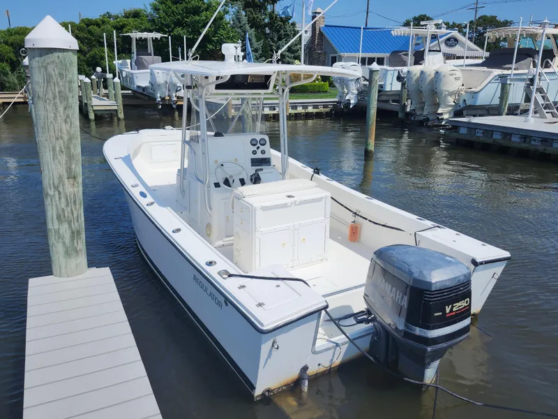 Slide: The Image of 2002 Regulator 23 Classic boat docked with Yamaha V250 outboard motor. - 5