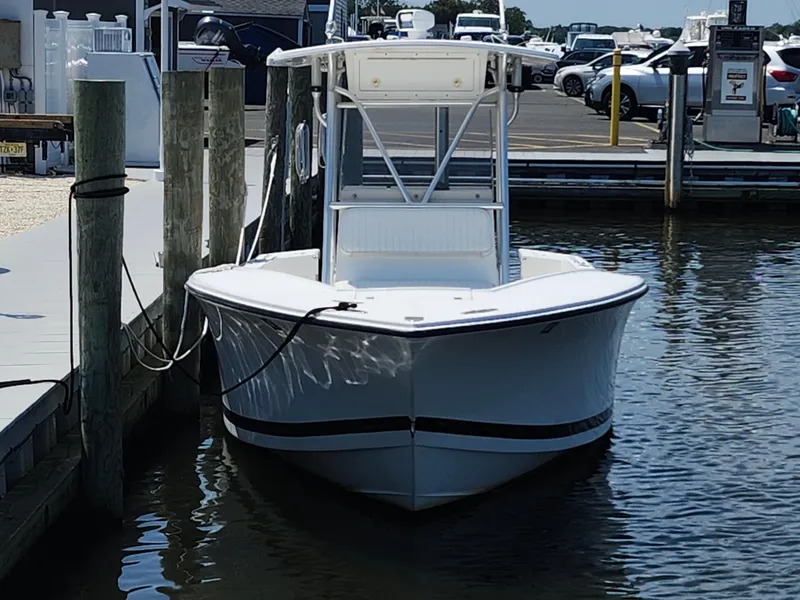 Slide: The Image of 2002 Regulator 23 Classic boat docked at marina, front view. - 7