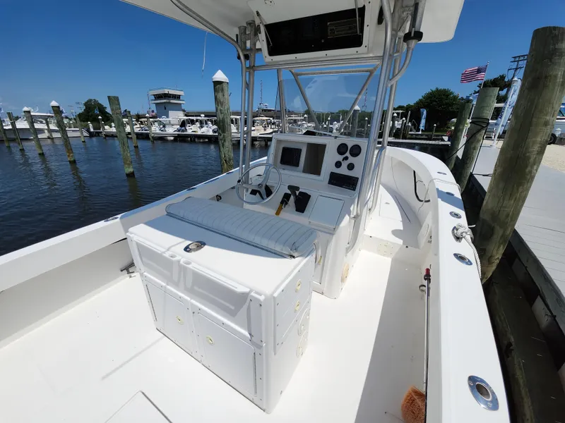 Slide: The Image of 2002 Regulator 23 Classic boat at marina, featuring helm and seating area. - 8