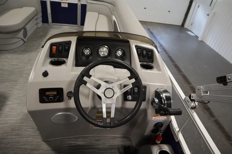 Slide: The Image of 2020 Bennington 16 SL boat dashboard with steering wheel and control panel. - 18