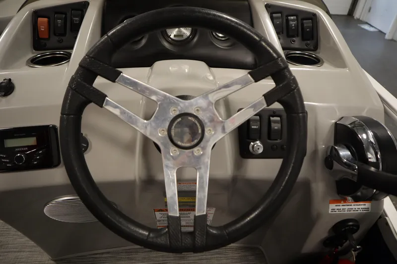 Slide: The Image of Steering wheel and dashboard of a 2020 Bennington 16 SL boat. - 19