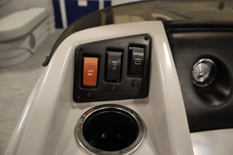 Slide: The Image of Control panel of 2020 Bennington 16 SL boat with switches and cup holder. - 21