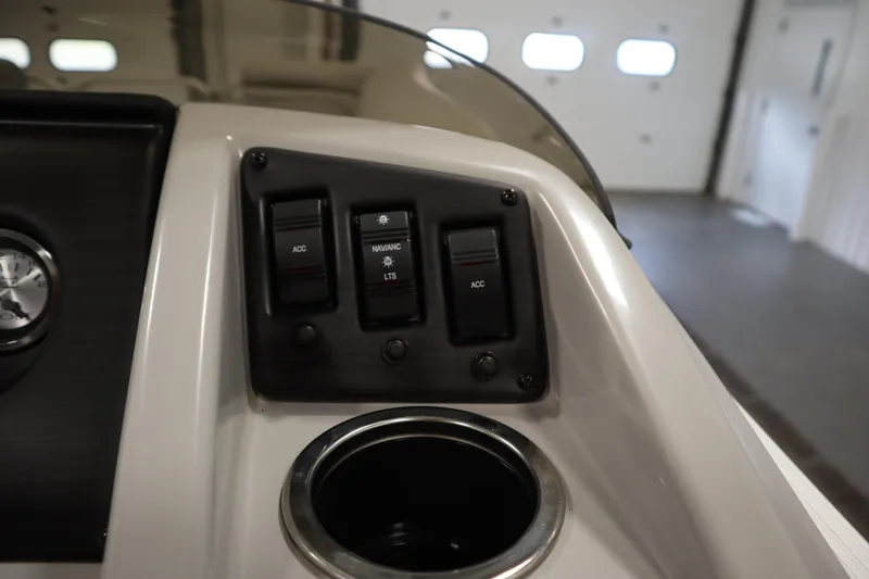 Slide: The Image of Control panel of 2020 Bennington 16 SL boat with switches and cup holder. - 23