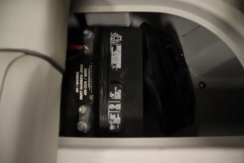 Slide: The Image of Battery compartment of a 2020 Bennington 16 SL boat, featuring a marine battery. - 29
