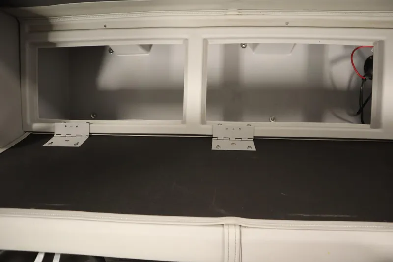Slide: The Image of Storage compartment of a 2020 Bennington 16 SL boat, featuring dual hinged access. - 31