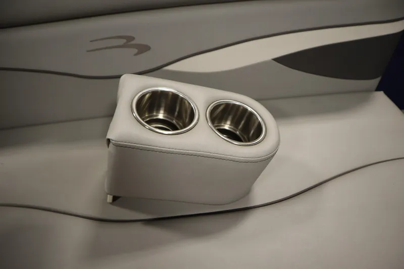 Slide: The Image of 2020 Bennington 16 SL boat interior with dual cup holders on gray seating. - 32