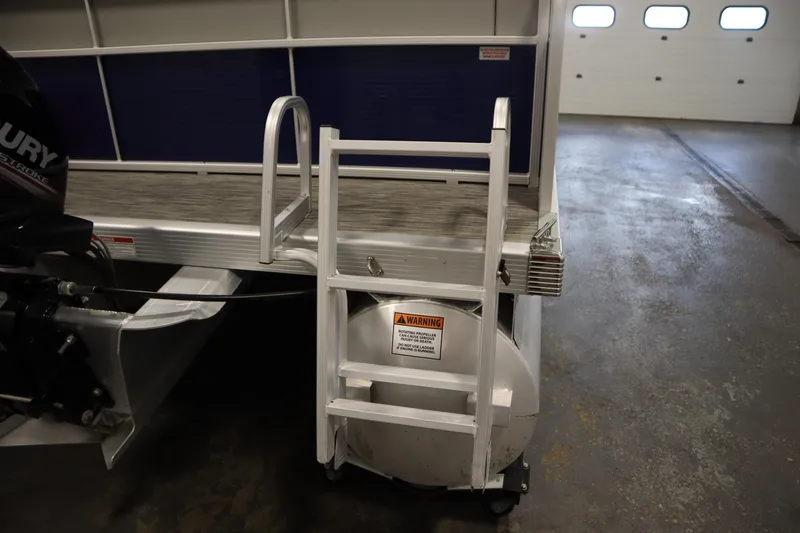 Slide: The Image of 2020 Bennington 16 SL boat with ladder and Mercury outboard motor in a garage. - 33