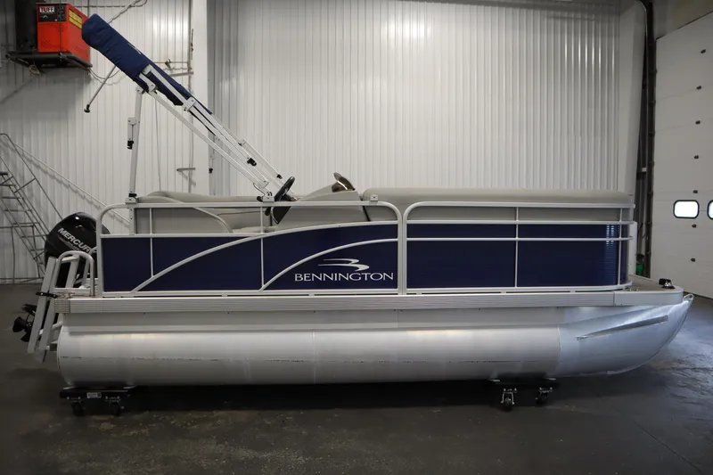 Slide: The Image of 2020 Bennington 16 SL pontoon boat in a warehouse setting. - 4
