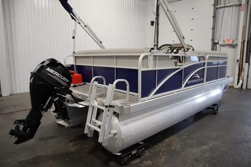 Slide: The Image of 2020 Bennington 16 SL pontoon boat with Mercury outboard motor in a garage. - 5