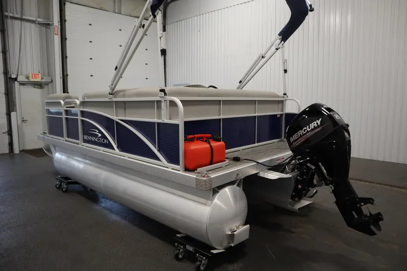 Slide: The Image of 2020 Bennington 16 SL pontoon boat with Mercury outboard motor in a garage. - 7