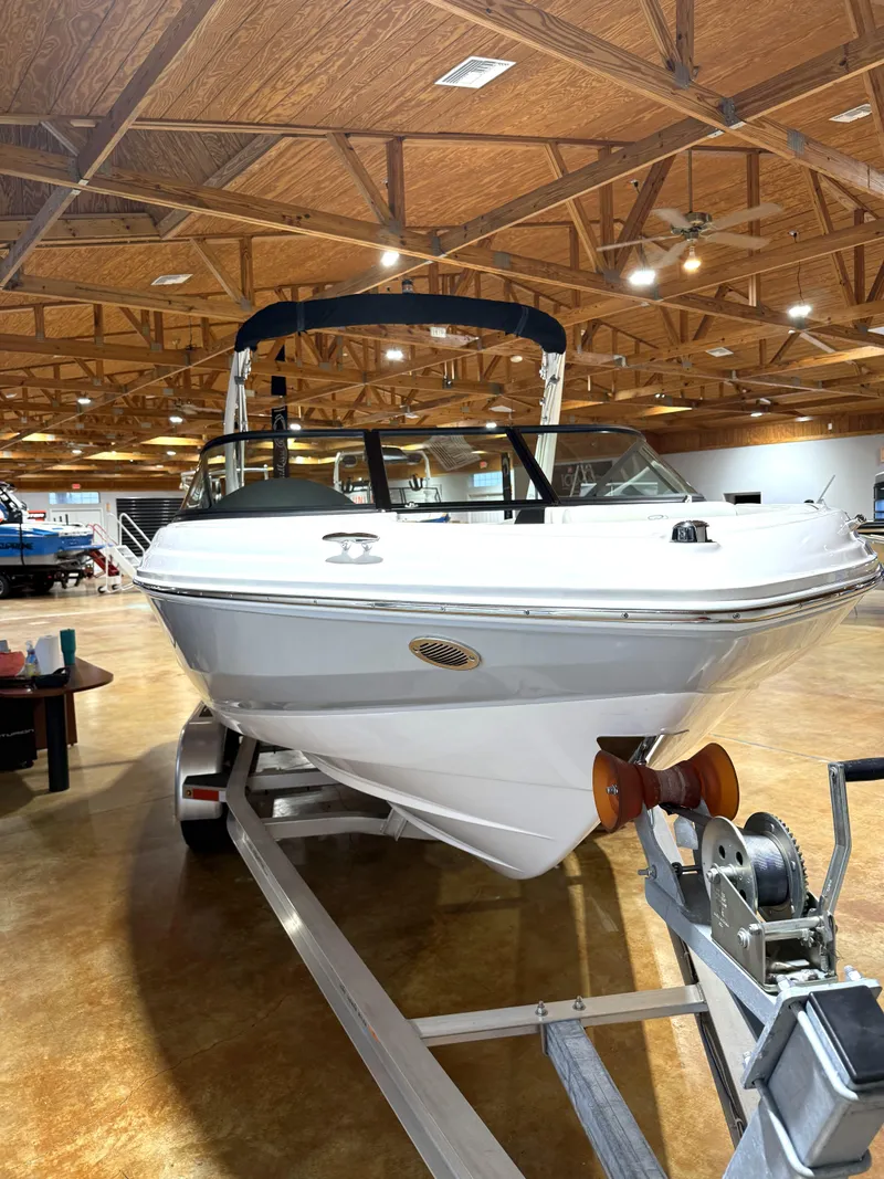 Slide: The Image of 2025 Regal 2000 ES boat on trailer in showroom with wooden ceiling. - 3