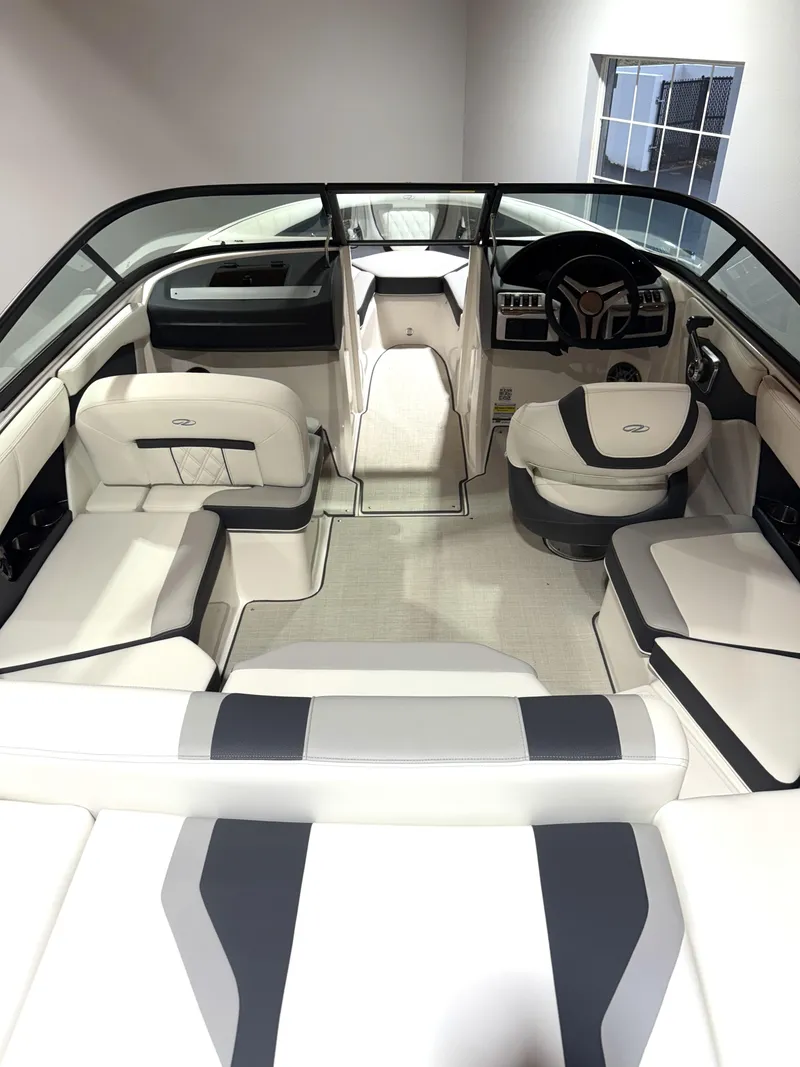 Slide: The Image of 2025 Regal 2000 ES boat interior with sleek white and gray seating, modern dashboard. - 4