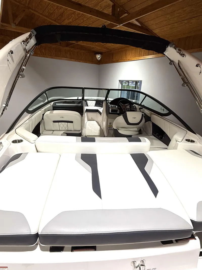 Slide: The Image of 2025 Regal 2000 ES boat interior with white and gray seating, under wooden ceiling. - 6