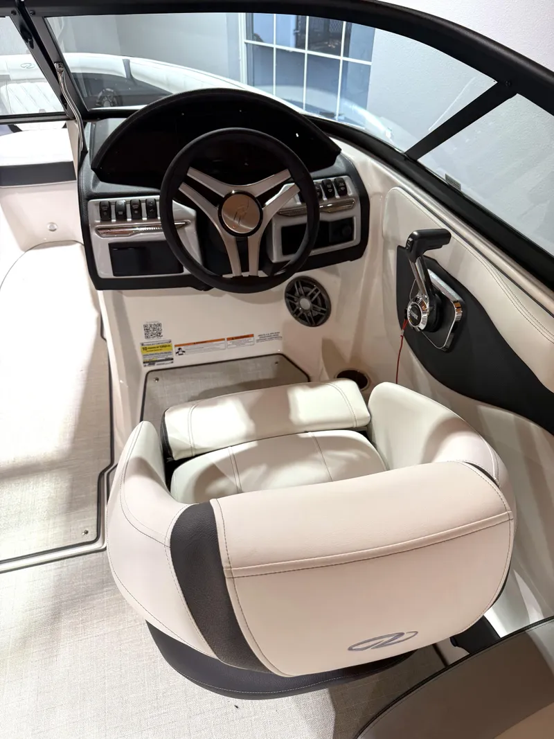Slide: The Image of Interior of 2025 Regal 2000 ES boat, featuring steering wheel and plush seating. - 8