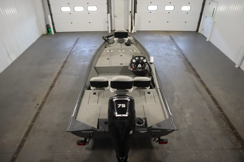 Slide: The Image of 2017 Tracker 20 CW Pontoon boat in a garage, rear view with motor. - 10