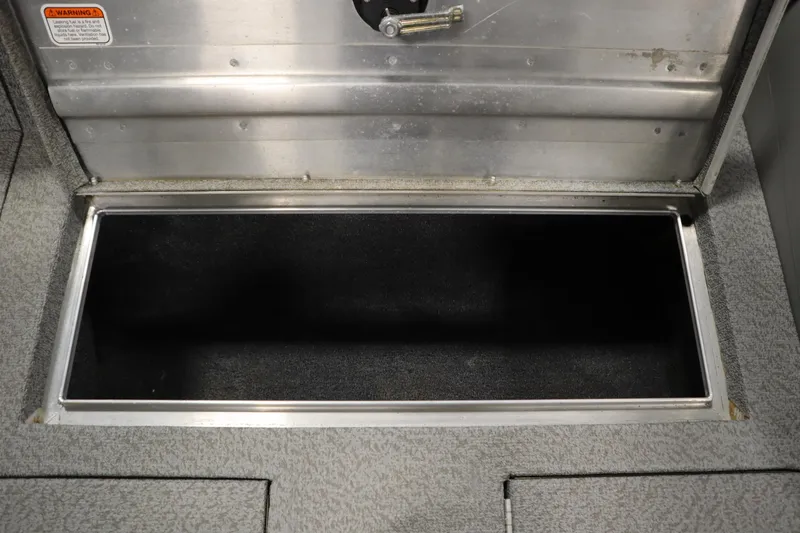 Slide: The Image of Storage compartment of a 2017 Tracker 20 CW Pontoon boat, open and empty. - 20