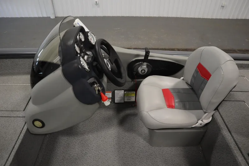 Slide: The Image of 2017 Tracker 20 CW Pontoon boat cockpit with steering wheel and cushioned seat. - 22
