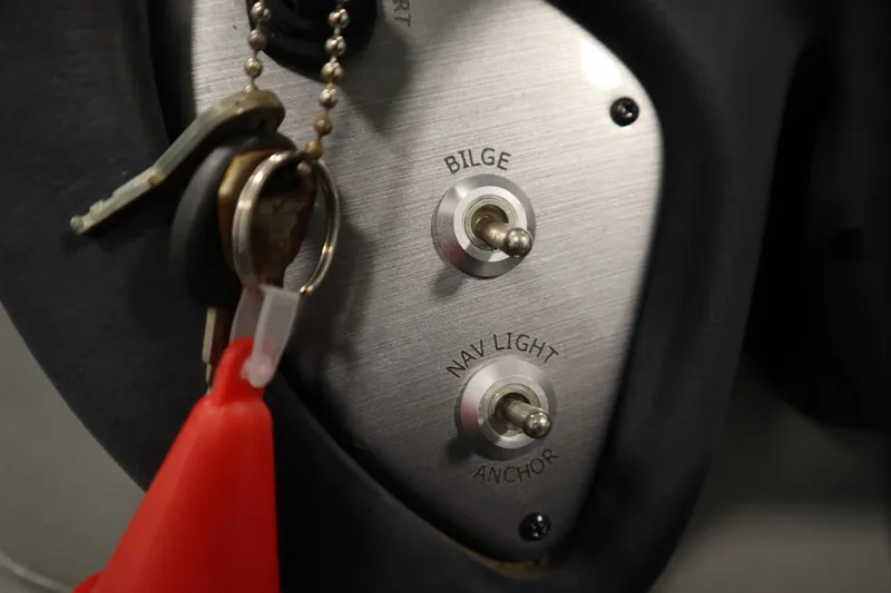 Slide: The Image of Control panel with switches for bilge and navigation lights on a 2017 Tracker 20 CW Pontoon. - 26