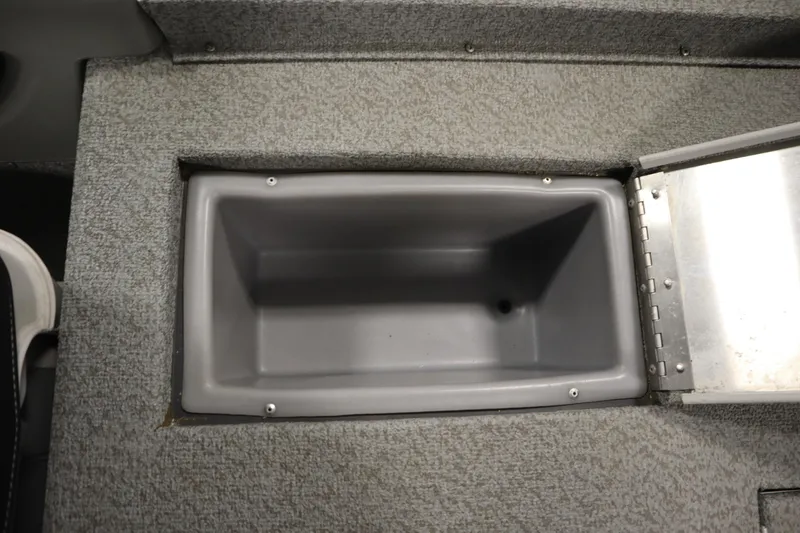 Slide: The Image of Storage compartment in 2017 Tracker 20 CW Pontoon boat, featuring gray interior and carpeted edges. - 40